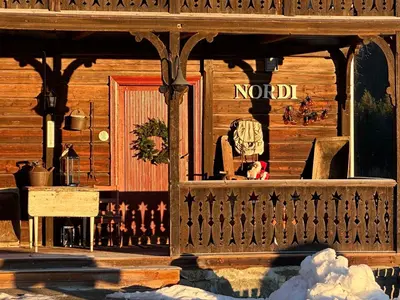 a store front of a wooden building with a porch at Nord-Garthus gård leilighet 1 in Hølera