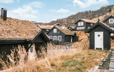 a row of black houses with a white door at Family Cabin With Ski Inout In Rauland in Rauland