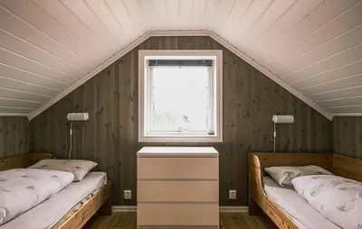 two beds in a room with a window at Family Cabin With Ski Inout In Rauland in Rauland