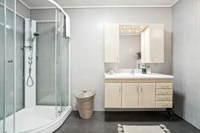 a bathroom with a shower and a sink and a mirror at Moderne rekkehus nært Ålesund in Valderøya