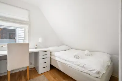 a white bedroom with a desk and a bed at Scandinavian Hideaway I Private Balcony in Bergen