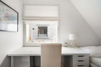 a bedroom with a window with a desk and a chair at Scandinavian Hideaway I Private Balcony in Bergen