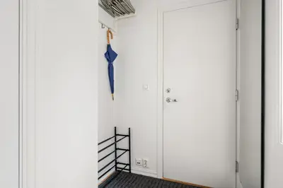 an umbrella hanging on a wall next to a door at Scandinavian Hideaway I Private Balcony in Bergen