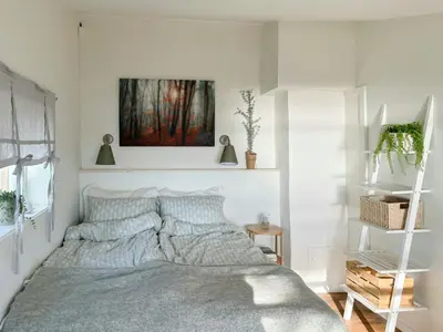 a bedroom with a bed and a painting on the wall at Family Cabin With Panoramic Views Of Tyrifjorden in Nes