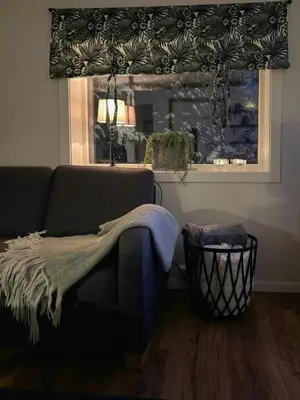 a living room with a couch and a window at Family Cabin With Panoramic Views Of Tyrifjorden in Nes