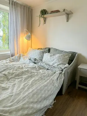 an unmade bed in a bedroom with a window at Family Cabin With Panoramic Views Of Tyrifjorden in Nes