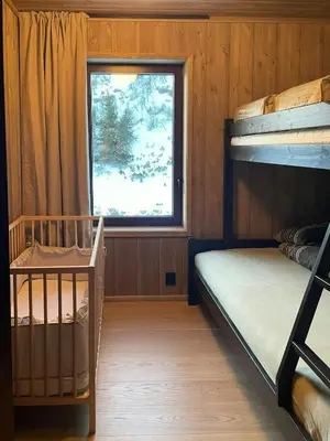 a bedroom with two bunk beds and a window at Architect Designed Mountain Cabin At Kvitfjell in Favang