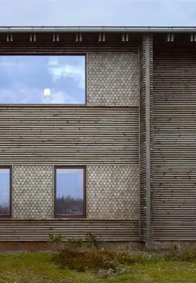 a building with three windows on the side of it at Architect Designed Mountain Cabin At Kvitfjell in Favang