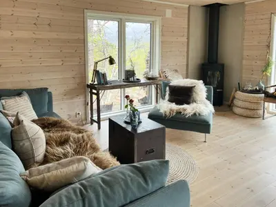a living room with a couch and a table at Charming Cabin In Jotunheimen in Vaga
