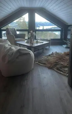 a living room with a couch and a coffee table at Mountain Cabin With Panoramic Views In Savalen in Tynset