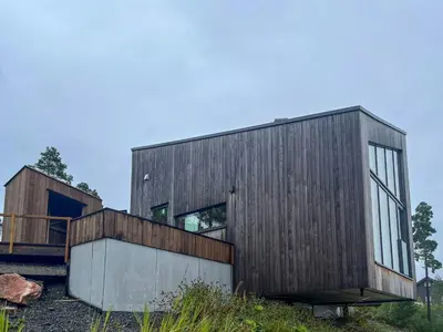 a wooden house on top of a hill at Architect-Designed Cabin With View In Molde in Røvik