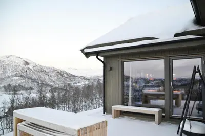 a cabin with a view of a snowy mountain at Mountain Cabin By The Ski Trails In Rauland in Rauland