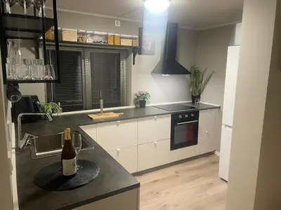 a kitchen with a bottle of wine on a counter at Trolladalen 8A1V in Sogndal