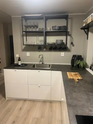 a kitchen with white cabinets and a sink at Trolladalen 8A1V in Sogndal
