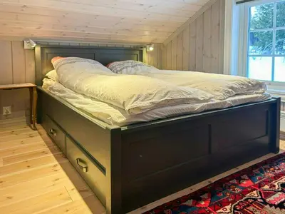 a bed with a wooden frame in a room at Family Cabin With Ski In Ski Out in Trysil