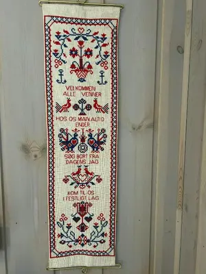 a cross stitch sign hanging on a wall at Family Cabin With Ski In Ski Out in Trysil