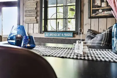a table with two glasses on top of it at Cosy Cabin With Annex At Blefjell in Kongsberg