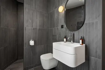 a bathroom with a white sink and a mirror at The Sognefjord Cabin in Kaupanger
