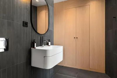 a bathroom with a white sink and a mirror at The Sognefjord Cabin in Kaupanger