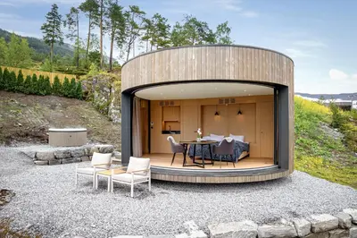 a circular house with a table and chairs in the middle at The Sognefjord Cabin 2 in Kaupanger