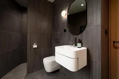 a bathroom with a sink and a toilet and a mirror at The Sognefjord Cabin 2 in Kaupanger