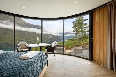 a bedroom with a bed and a table with a view at The Sognefjord Cabin 2 in Kaupanger