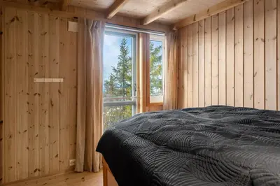 a bedroom with a bed and a large window at Panoramautsikt i Valdres Perfekt for ski og fjellturer året rundt in Aurdal