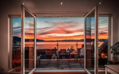 a view of a sunset from the balcony of a house at Penthouse Apartment in Bergen
