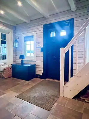 a blue door in a room with a staircase at Mountain Cabin With Panoramic Views At Hummelfjell in Os