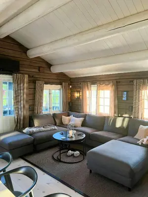 a living room with a couch and a table at Mountain Cabin With Panoramic Views At Hummelfjell in Os