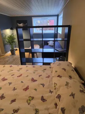 a bedroom with a bed with flowers on it at Hagestova in Volda