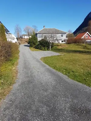 an empty road in front of a house at Hagestova in Volda