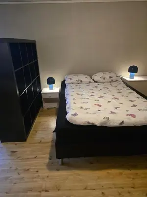 a bedroom with a bed with two pillows on it at Hagestova in Volda