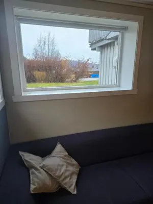 a pillow sitting in front of a window at Hagestova in Volda