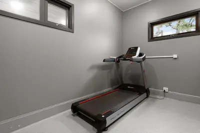 a room with a treadmill in the corner of a room at High-End Villa with Private rooftop and sea line in Bergen