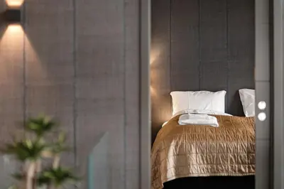 a bedroom with a bed with two pillows at High-End Villa with Private rooftop and sea line in Bergen
