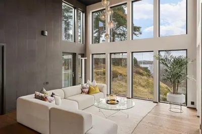 a living room with a white couch and large windows at High-End Villa with Private rooftop and sea line in Bergen