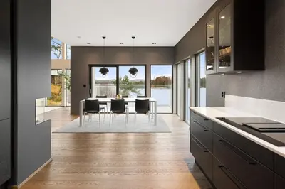 a kitchen with a table with chairs and a dining room at High-End Villa with Private rooftop and sea line in Bergen