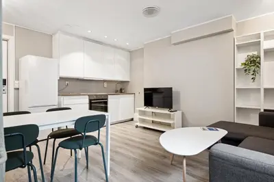 a kitchen and living room with a table and chairs at Apt 500 m to Bryggen - Perfect location in Bergen