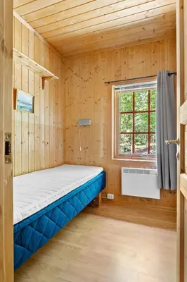 a small room with a bed and a window at Cottage w Wilderness Feeling 20 min from airport in Maura