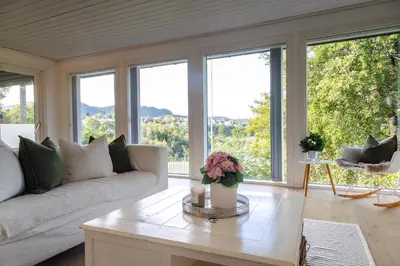 a living room with a couch and a table at Apartment with stunning fjord view near Ålesund in Ålesund