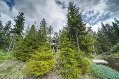 a house in the middle of a forest with trees at Faråsen Luxury Treetop Cabin - Sleep Among the Trees in Ringsaker