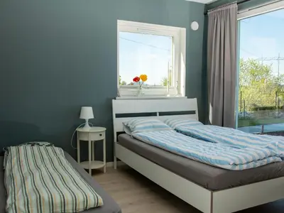 a bedroom with a bed and a window at Hytte Hammarslandbakken in Bergen