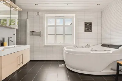 a white bathroom with a tub and a sink at Trolltunga Fjord Living in Tysso