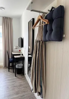 a room with a wall with a bunch of clothes at Jibben Hotell in Måløy