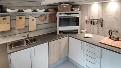 a kitchen with white cabinets and a sink at Hytta Idyll in Dagali