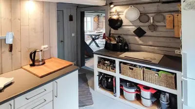 a kitchen with white cabinets and a counter at Hytta Idyll in Dagali