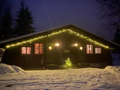 a house with christmas lights on it in the snow at Newly renovated cabin near Ål city center, mountains & ski resort in Liagardane