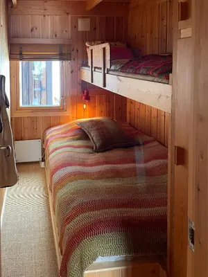 a bedroom with two bunk beds and a window at 70S Architectural Cabin With Views In Hemsedal in Hemsedal