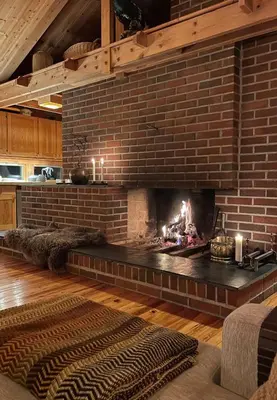 a brick fireplace in a living room with a fire place at 70S Architectural Cabin With Views In Hemsedal in Hemsedal